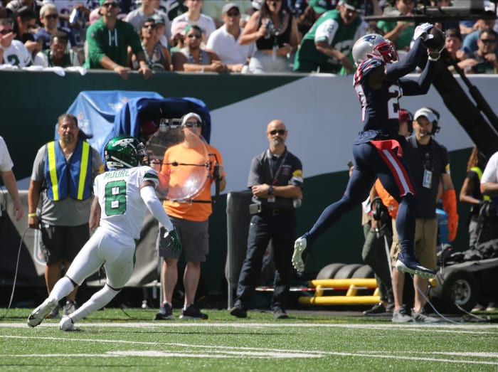 Intended receiver Elijah Moore of the Jets watches as J.C. Jackson of the Patriots intercepts a pass. Chris Pedota, NorthJersey.com via Imagn Content Services, LLC